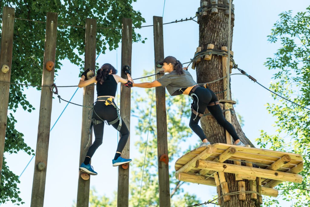 Adventurous Girls Engaging in a High Ropes Course Challenge That Tests Their Limits