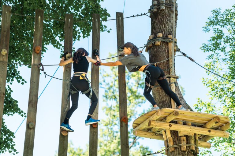 Adventurous Girls Engaging in a High Ropes Course Challenge That Tests Their Limits