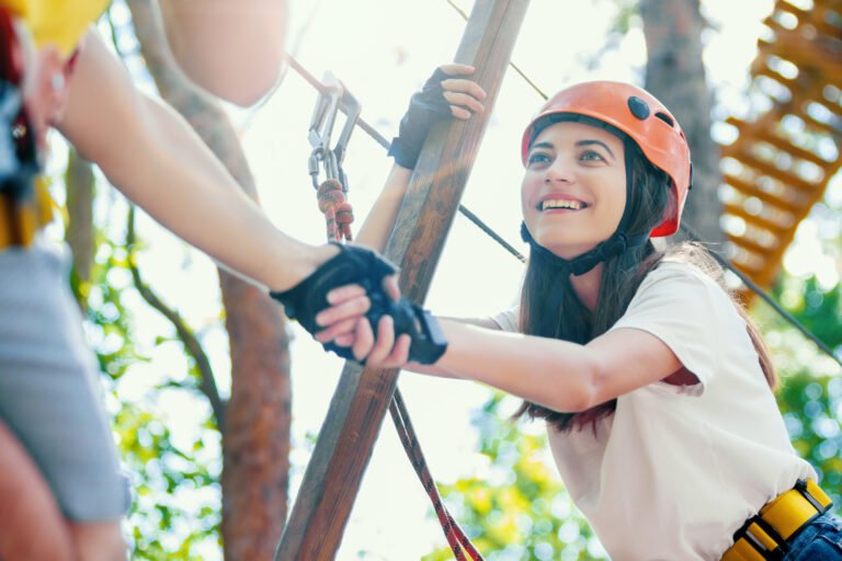 Couple in love enjoy active leisure in extreme rope park