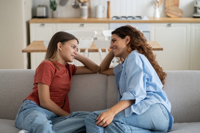 Loving mother listening to daughter with empathy and understanding, child sharing secrets with mom