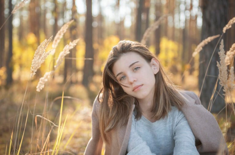 Young teenager girl in the autumn forest