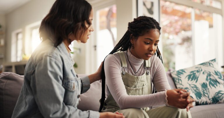 Sad, woman and friends on couch for comfort with breakup and relationship fail in home. Support, people and empathy for cheating mistake, console and kindness for mental health advice in living room