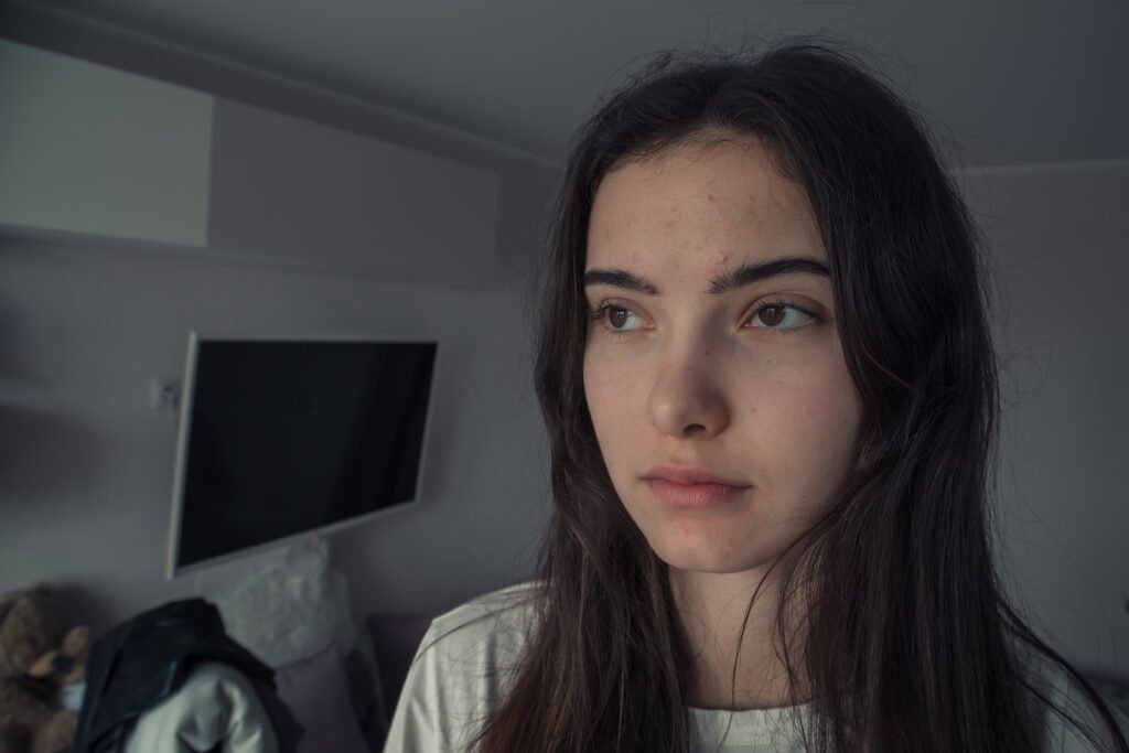 Large scale portrait of candid teen girl looking at window
