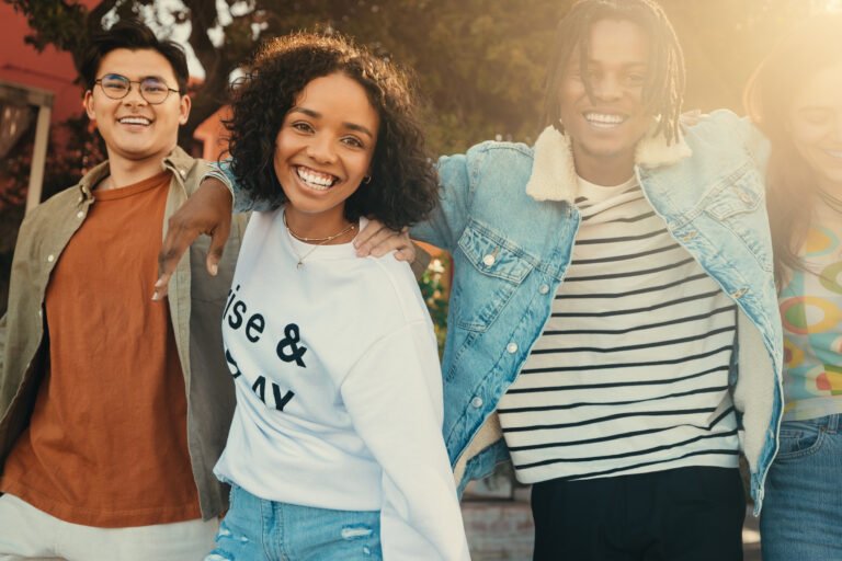 Happy friends smiling and enjoying a fun moment together outdoors