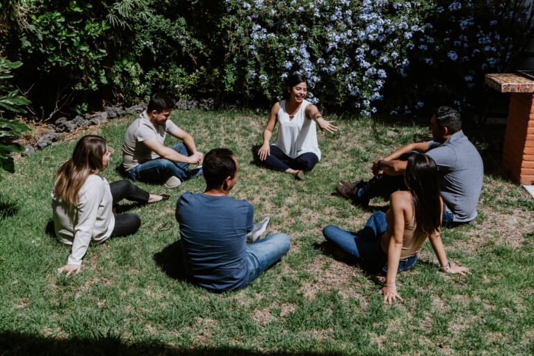 hispanic young people seated in circle on grass and participating at group therapy session in Mexico Latin America