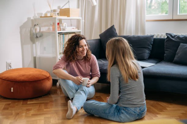 mother and teenager daughter talking at home