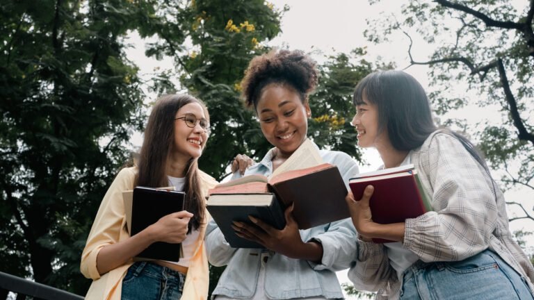 Group of multi-ethnic Diversity female students reading a book and do homework happily .group of multi-ethnic female students reading a book and do homework happily .Bookworm woman education.