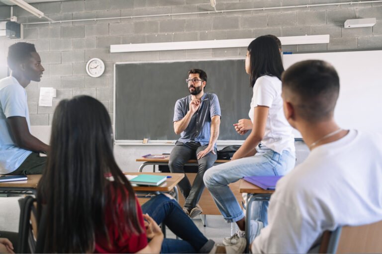 Teenager Teenager students listening and talking to friendly young male teacher - Group discussion in High School Education listening and talking to friendly young male teacher