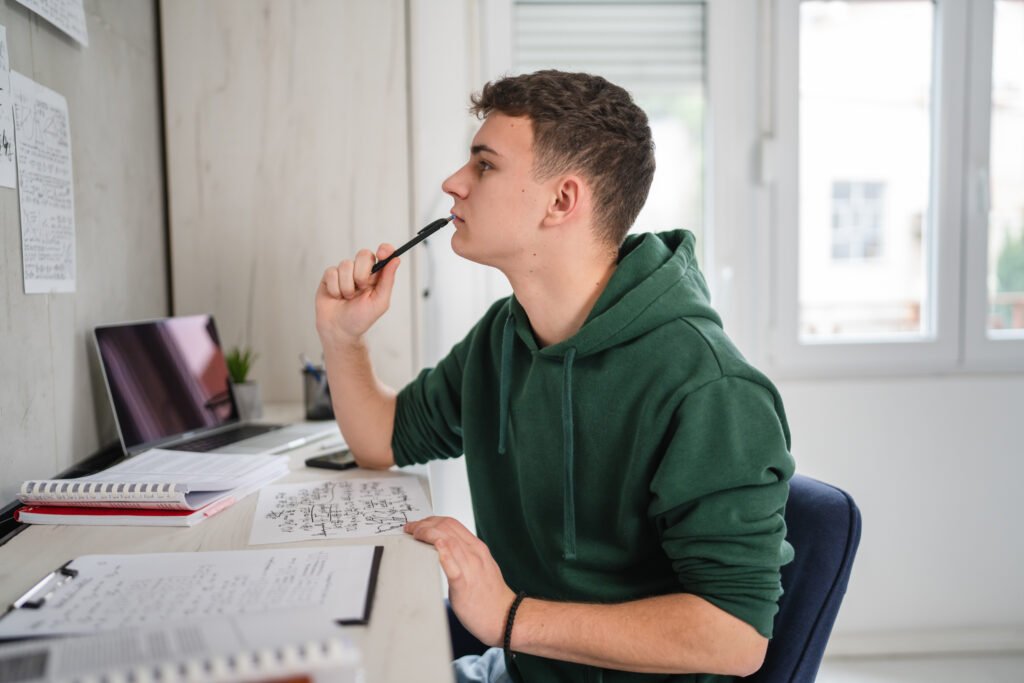 Young man caucasian teenager learning study at home education concept