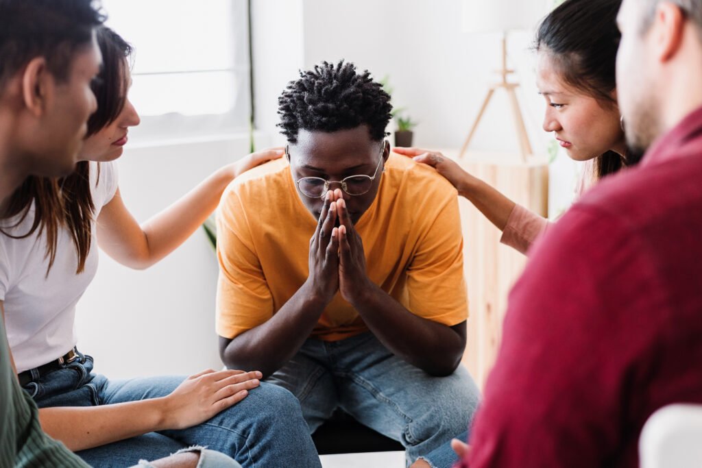 Group of people sitting in circle on therapy meeting