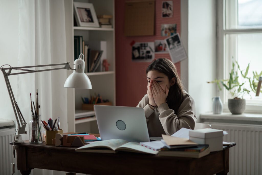 Young teenage girl studying in her room.