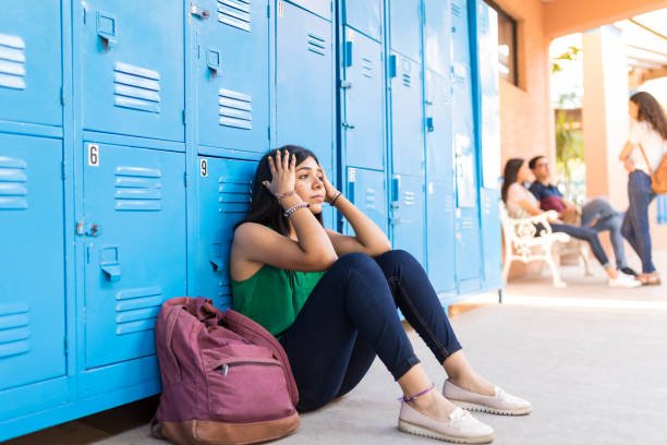 Latin female student feeling stressed in hallway at university