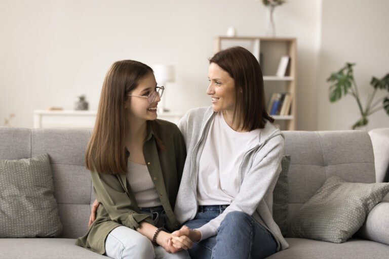 Positive mom and teenager kid enjoying conversation, friendship