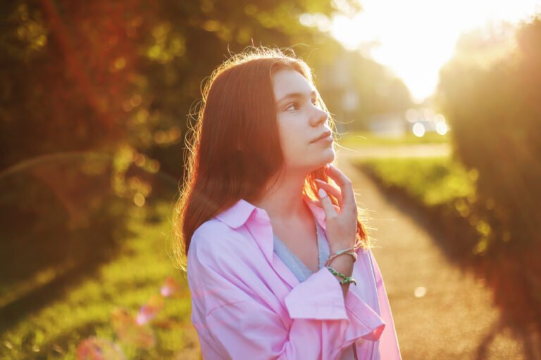 portrait of beautiful girl in the sunlight at sunset