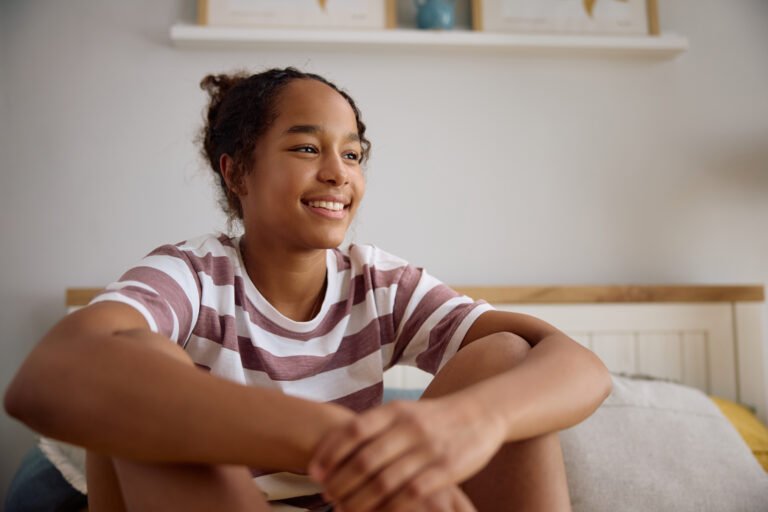 Happy black teenage girl relaxing at home.