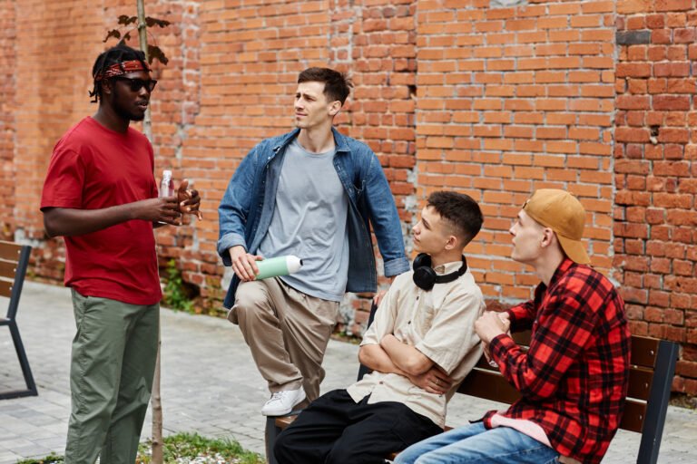 Young Men Chatting in City Street