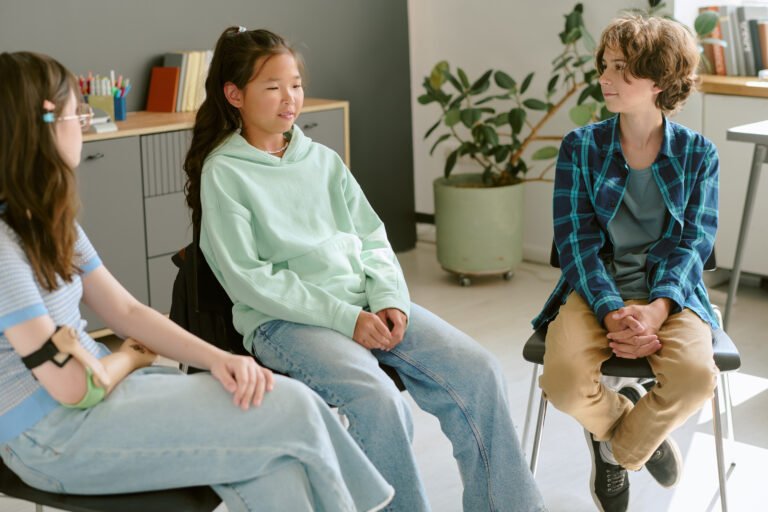 Multiethnic Teenagers Sitting in Circle Engaging in Group Conversation