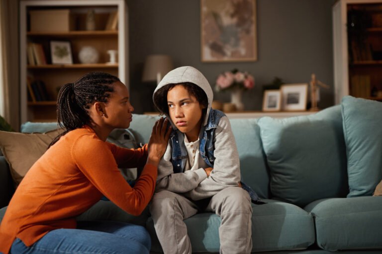 Mother and son talking about teenage problems at home