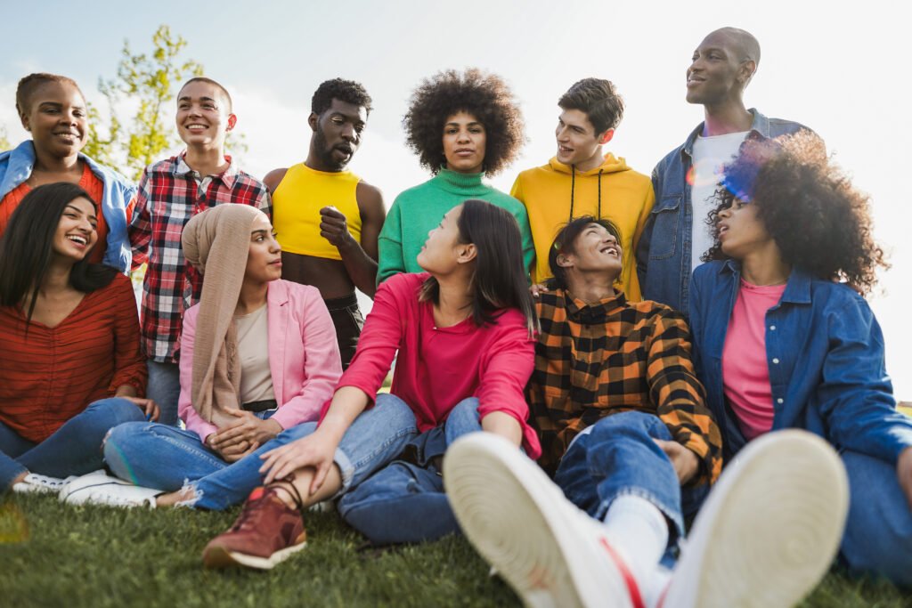 Group of diverse people having fun outdoor at city park - Diversity, lifestyle and multiracial community concept - Main focus on center african girl face