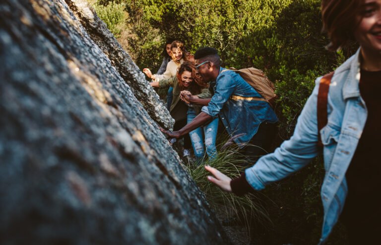 Friends walking through a mountain trail