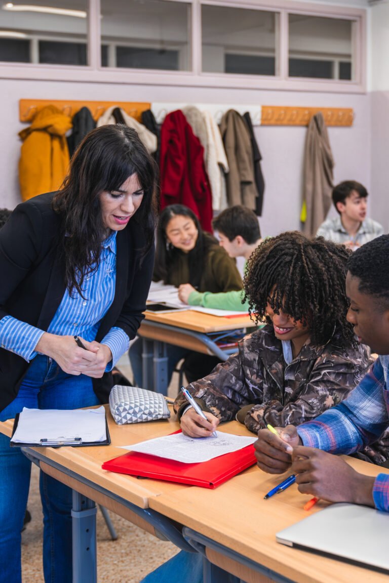 High school teacher helping students with their assignment