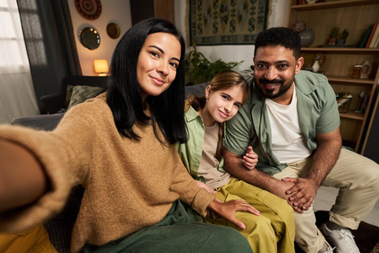 Smiling Family Taking Selfie on Cozy Living Room Sofa