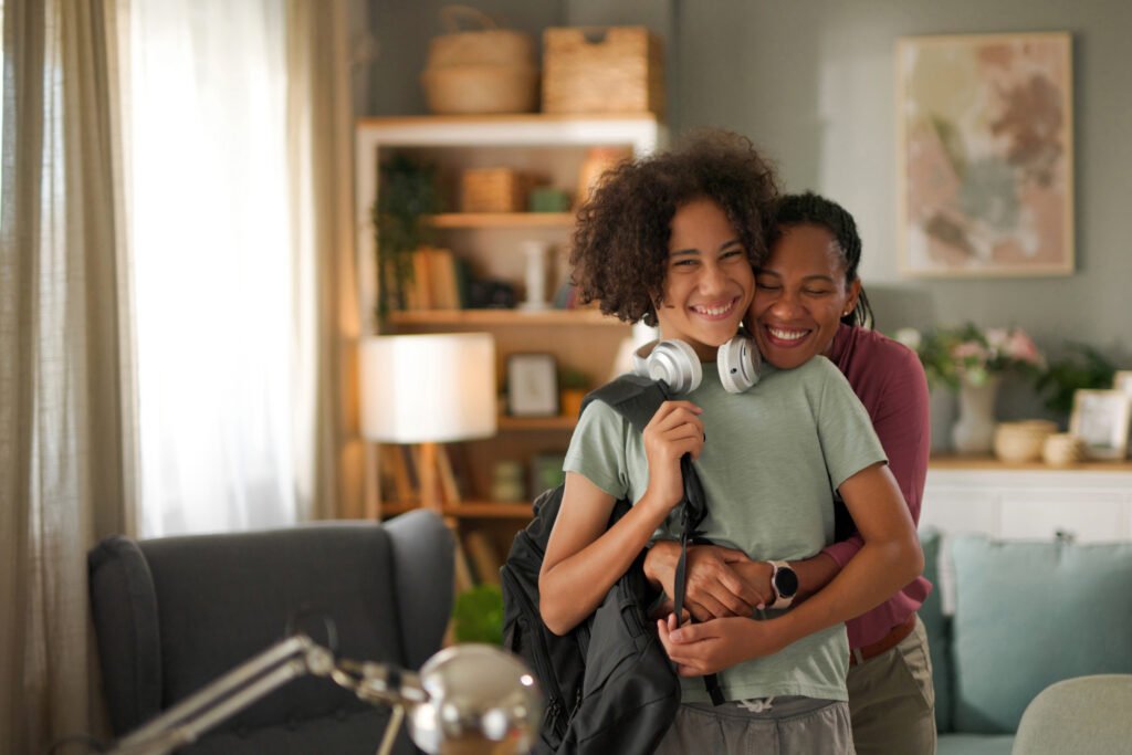 Teenage boy with his mother on the first day of school