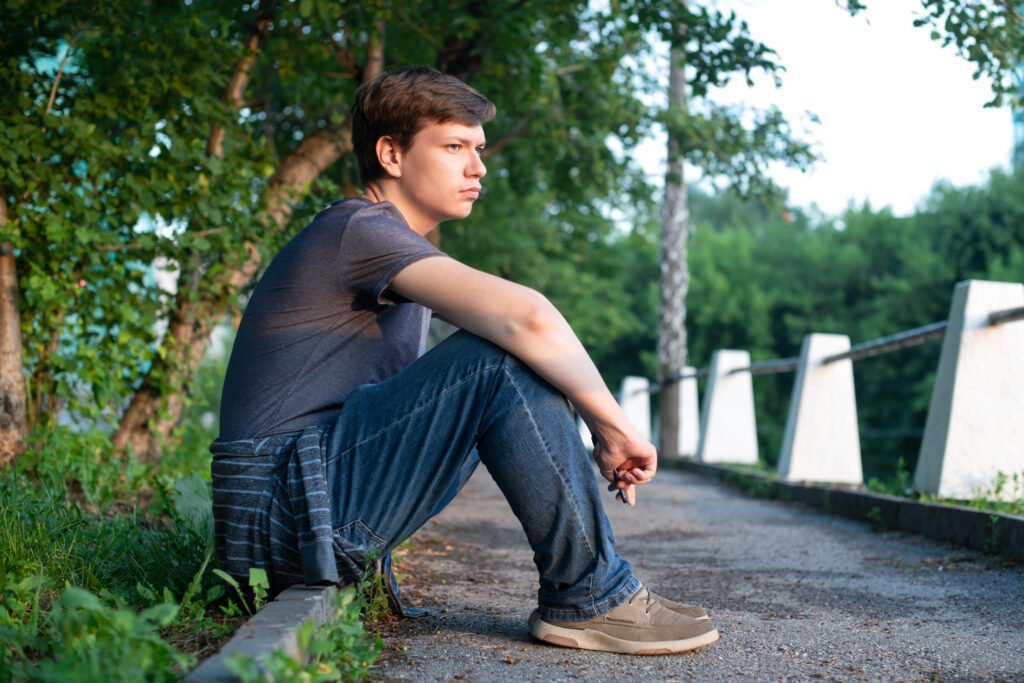 Young teen introvert student on a solo walk in the park in the summer.
