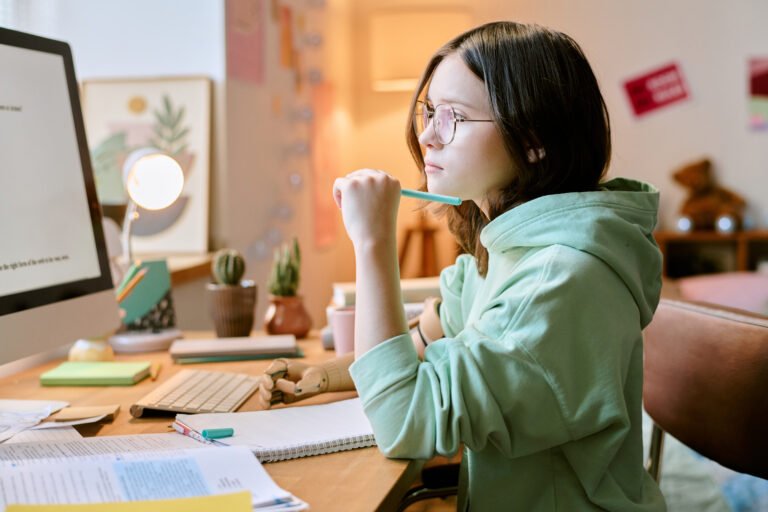 Studying Student with Prosthetic Arm Using Computer in Comfortable Home Environment