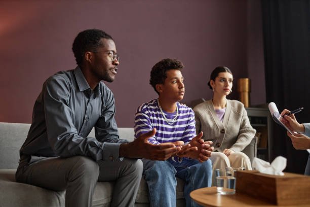 Family with teenage boy explaining problems to psychologist