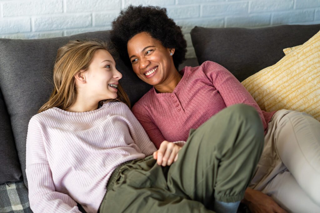 Loving african american foster care parent single mother embrace teen daughter