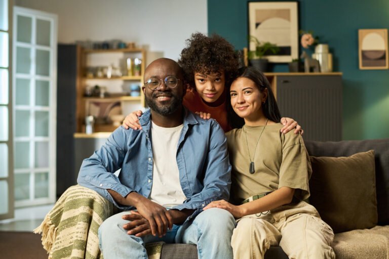 Portrait of Multiethnic Young Adult Family Smiling and Relaxing Together Indoors