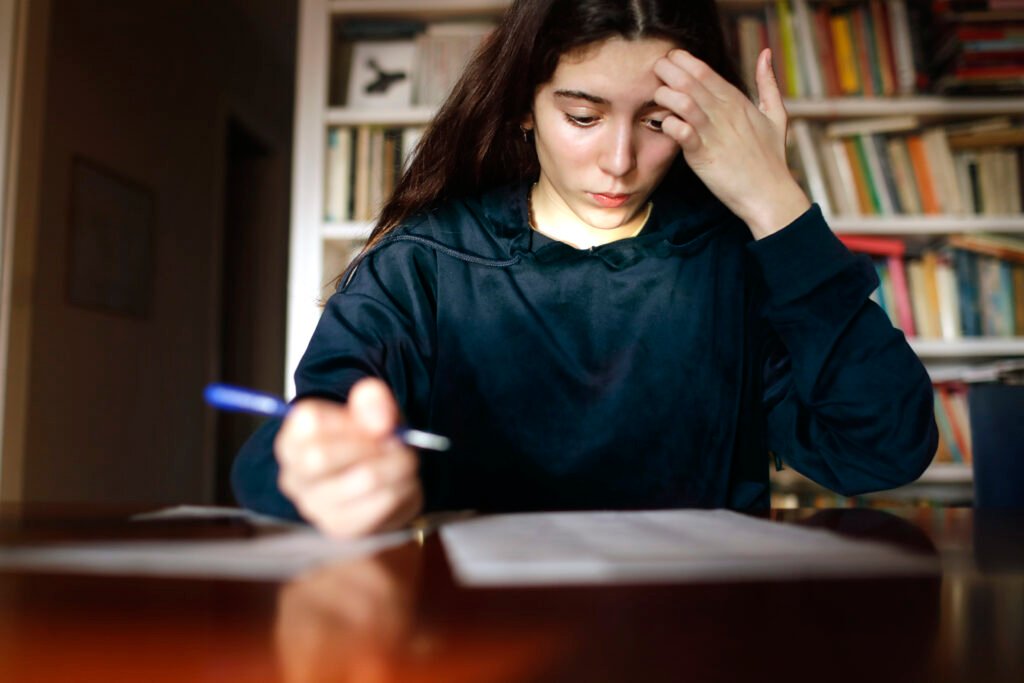 teenage girl studying in the library