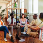 Five diverse young people on group therapy session