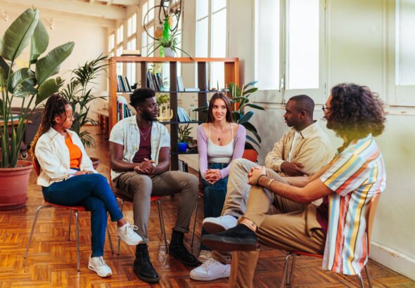 Five diverse young people on group therapy session
