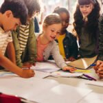 Group of children doing an art project with their teacher